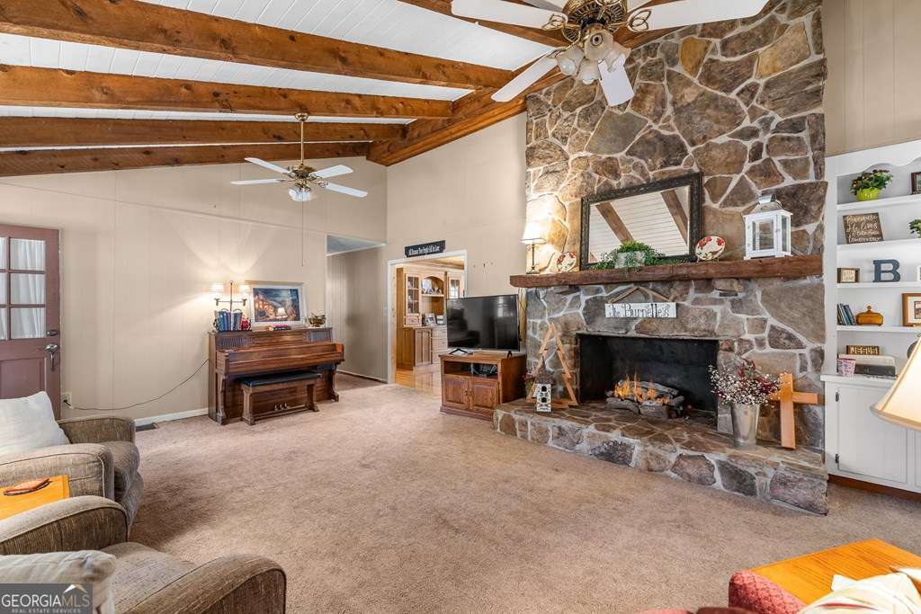 2164 Yukon Road Ellijay, GA 30536 - Photo 22 of 43 a living room with furniture and a fireplace