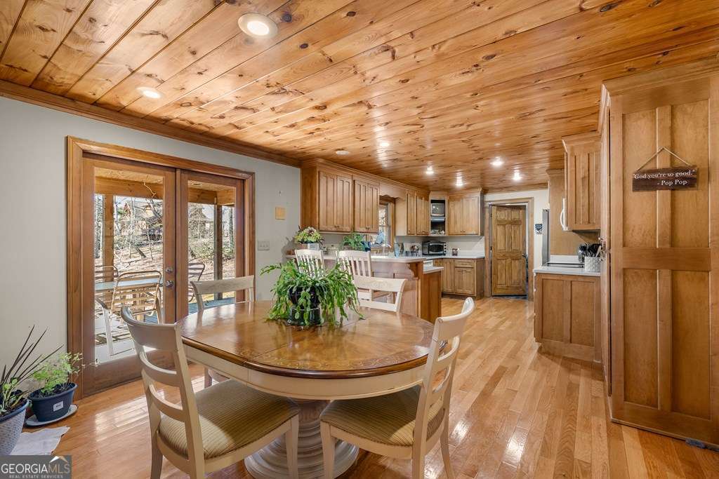 2164 Yukon Road Ellijay, GA 30536 - Photo 25 of 43 a view of a dining room with furniture window and wooden floor