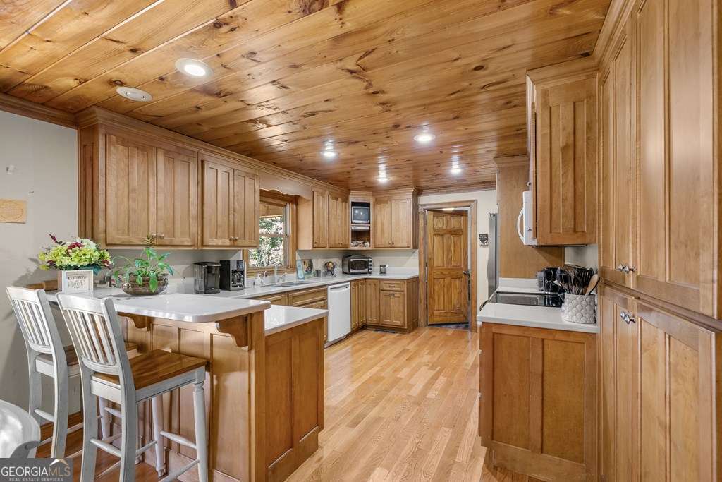2164 Yukon Road Ellijay, GA 30536 - Photo 26 of 43 a kitchen with sink refrigerator and cabinets