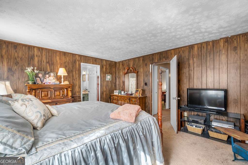 2164 Yukon Road Ellijay, GA 30536 - Photo 34 of 43 a bedroom with a bed and a flat screen tv