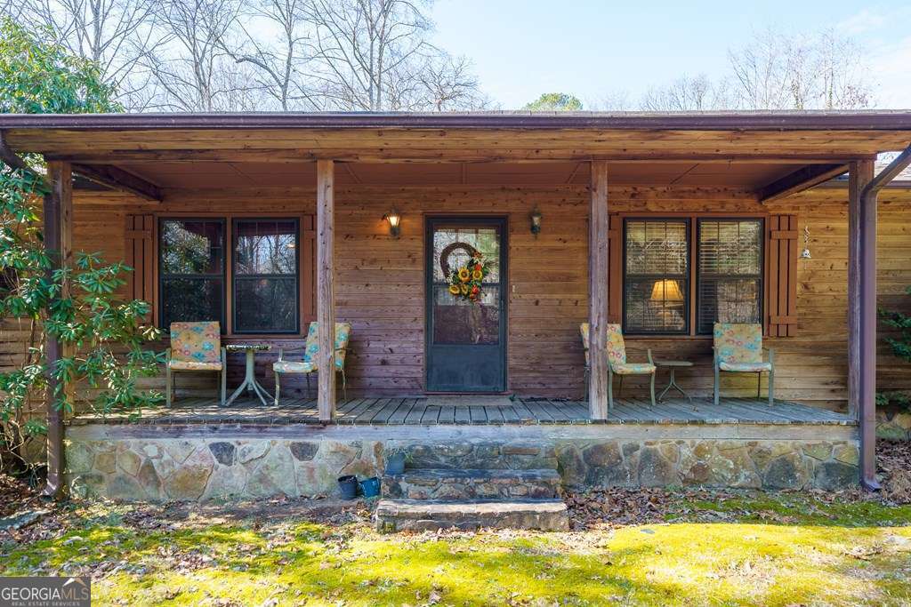 2164 Yukon Road Ellijay, GA 30536 - Photo 7 of 43 a view of a brick house with large windows