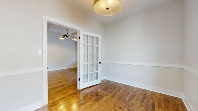 a view of empty room with wooden floor