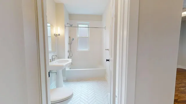 a bathroom with a toilet a sink and bathtub
