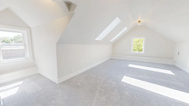 an empty room with windows and entrance