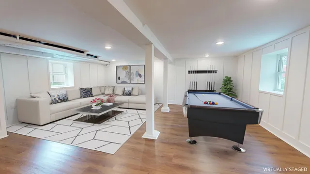 a living room with furniture and wooden floor