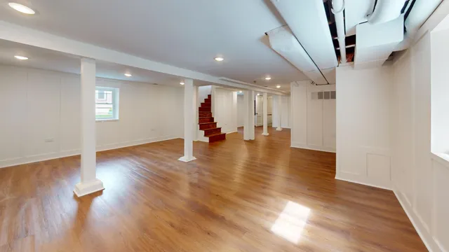 a view of an empty room with wooden floor