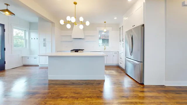 a kitchen with stainless steel appliances a refrigerator sink and cabinets