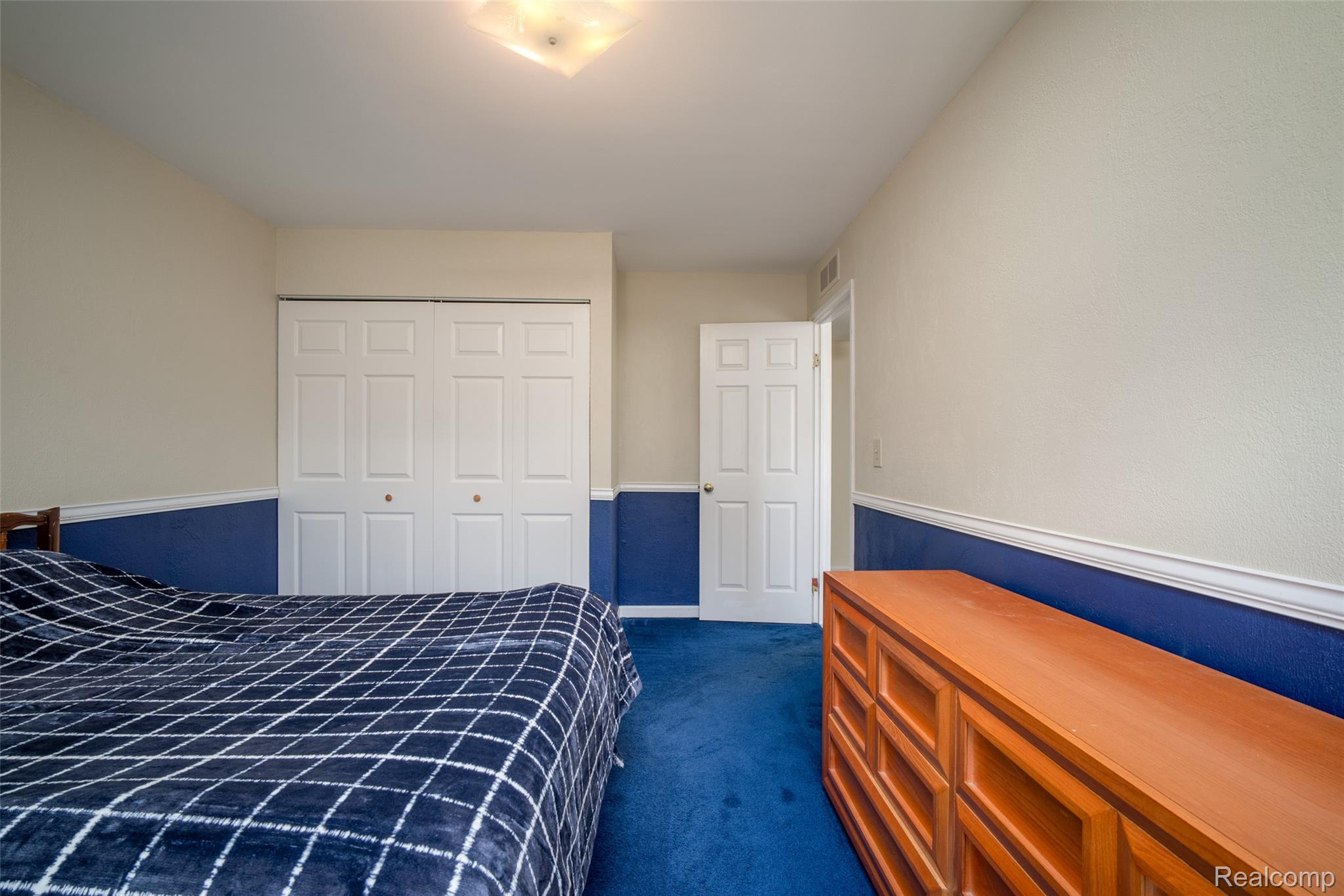 22533 Winfield Road Novi, MI 48375 - Photo 14 of 43 Interior room featuring blue carpeting, two-tone walls with a chair rail, and a semi-flush ceiling light fixture