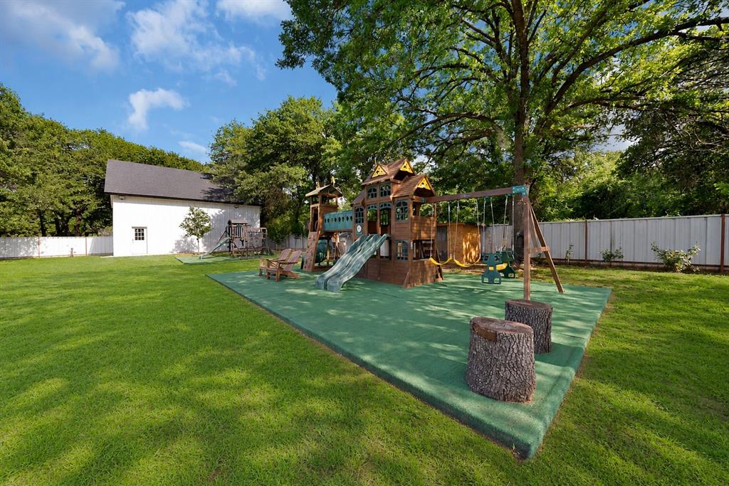 620 East 6th Street Springtown, TX 76082 - Photo 28 of 40 a view of a backyard with table and chairs potted plants and large tree