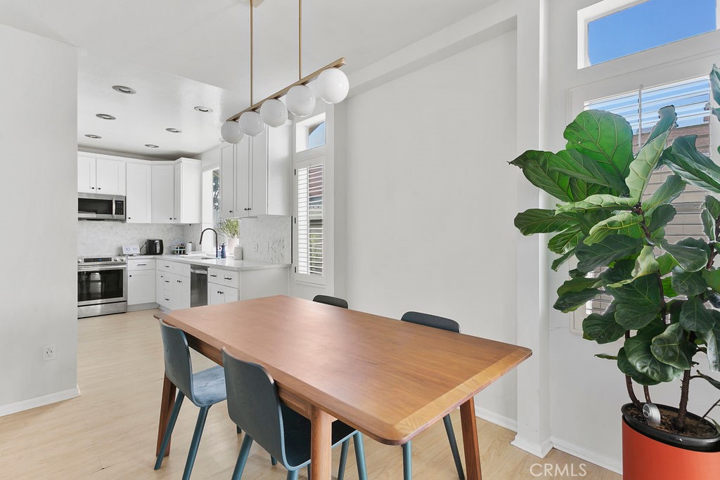 2575 Elden Avenue, Unit 2 Costa Mesa, CA 92627 - Photo 3 of 12 a view of a dining room with furniture and a potted plant