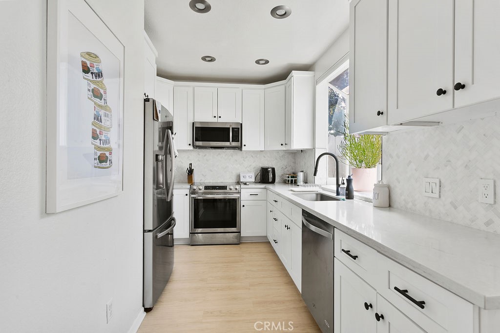 2575 Elden Avenue, Unit 2 Costa Mesa, CA 92627 - Photo 4 of 12 a kitchen with stainless steel appliances a refrigerator sink and microwave