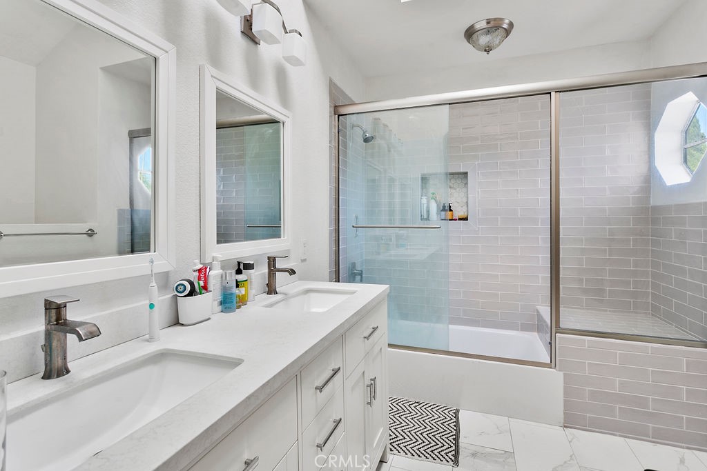2575 Elden Avenue, Unit 2 Costa Mesa, CA 92627 - Photo 6 of 12 a bathroom with a double vanity sink mirror double shower