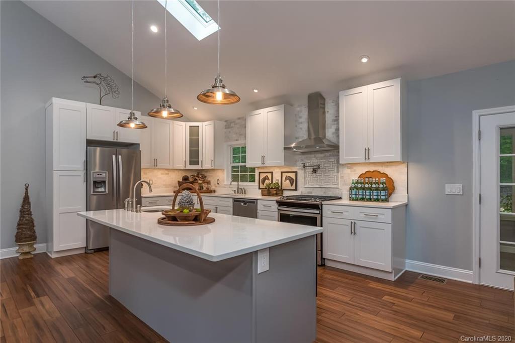 603 Vineyard Road Tryon, NC 28782 - Photo 11 of 39 a kitchen with stainless steel appliances granite countertop a refrigerator a stove and a wooden floors