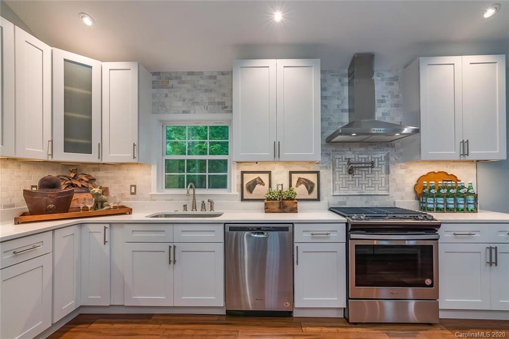 603 Vineyard Road Tryon, NC 28782 - Photo 12 of 39 a kitchen with stainless steel appliances granite countertop a stove and a sink