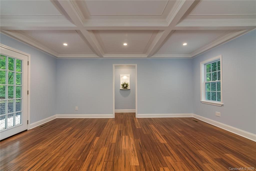 603 Vineyard Road Tryon, NC 28782 - Photo 15 of 39 a view of an empty room with wooden floor and a window