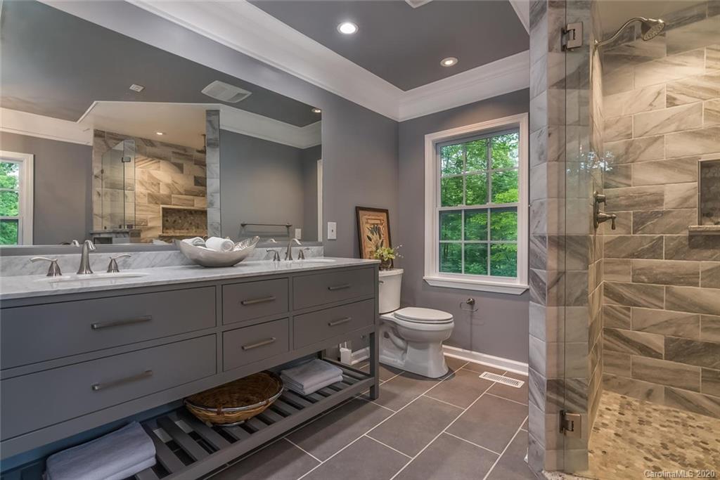 603 Vineyard Road Tryon, NC 28782 - Photo 16 of 39 a bathroom with a double vanity sink mirror and toilet