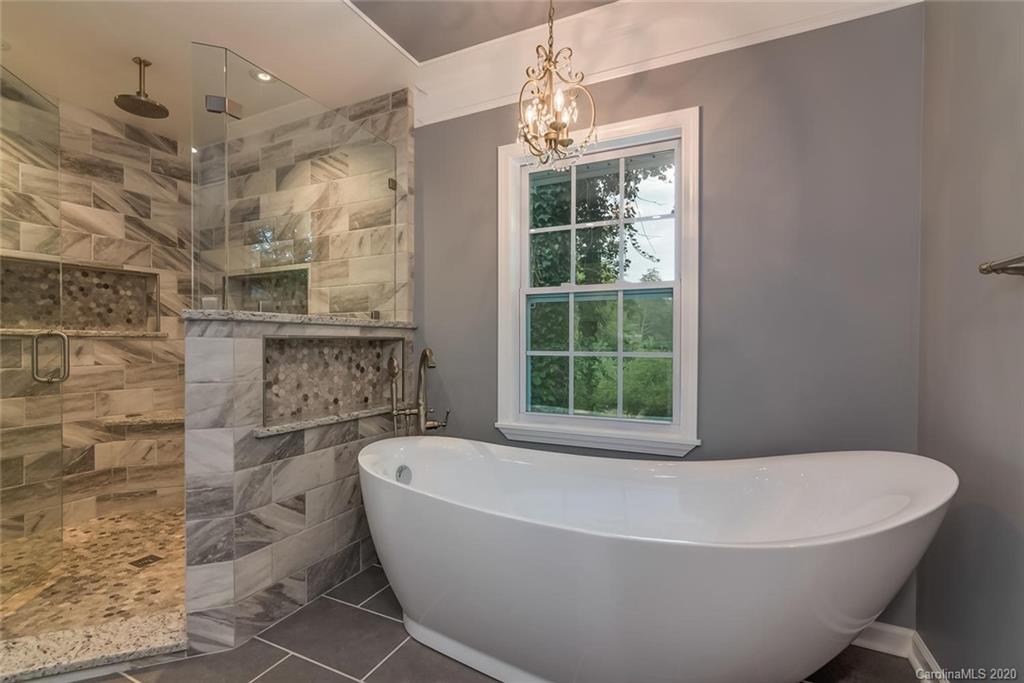603 Vineyard Road Tryon, NC 28782 - Photo 17 of 39 a white bath tub sitting in a bathroom next to a window