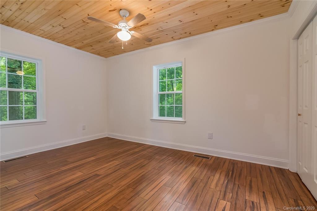 603 Vineyard Road Tryon, NC 28782 - Photo 24 of 39 an empty room with wooden floor and windows