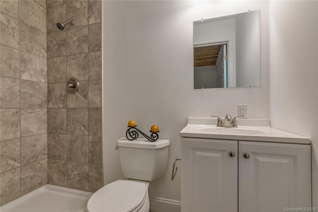 603 Vineyard Road Tryon, NC 28782 - Photo 25 of 39 a bathroom with a toilet sink and mirror