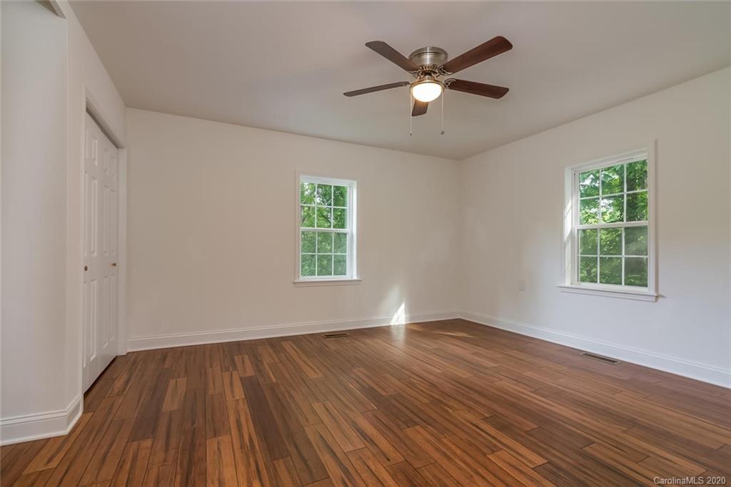 603 Vineyard Road Tryon, NC 28782 - Photo 26 of 39 wooden floor in an empty room with a window