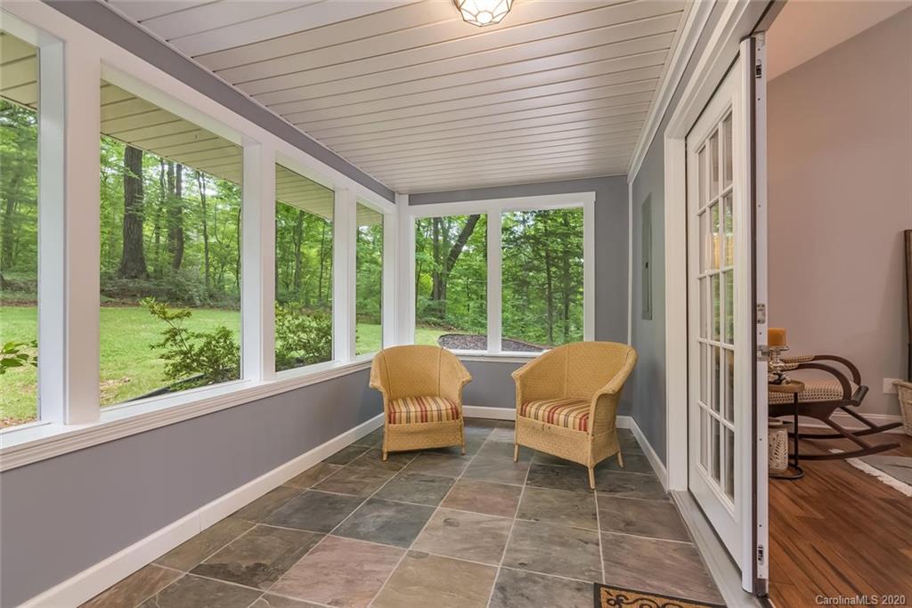 603 Vineyard Road Tryon, NC 28782 - Photo 29 of 39 a balcony with couple of chairs and a large window