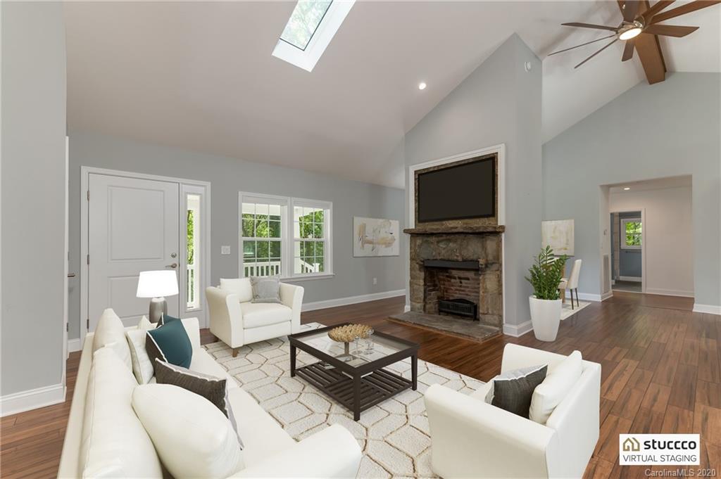603 Vineyard Road Tryon, NC 28782 - Photo 4 of 39 a living room with furniture a fireplace and a flat screen tv