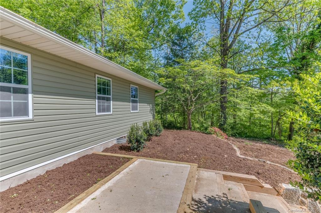 603 Vineyard Road Tryon, NC 28782 - Photo 33 of 39 a view of a backyard with potted plants