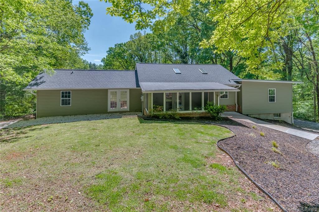 603 Vineyard Road Tryon, NC 28782 - Photo 36 of 39 a front view of a house with a garden