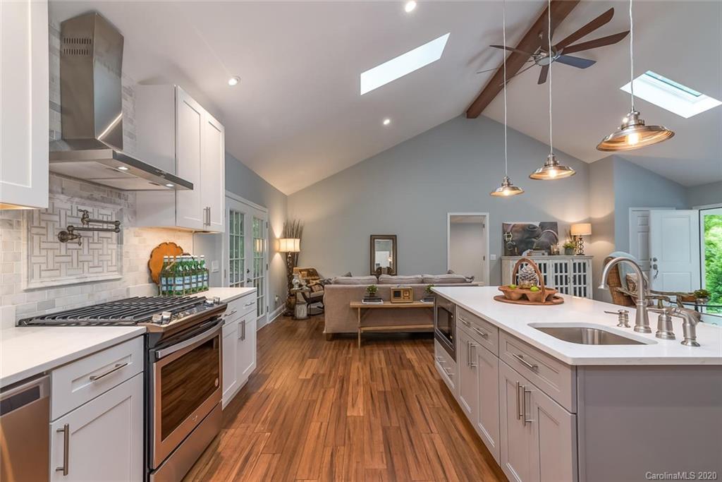 603 Vineyard Road Tryon, NC 28782 - Photo 8 of 39 a kitchen with granite countertop a sink a counter space appliances and cabinets