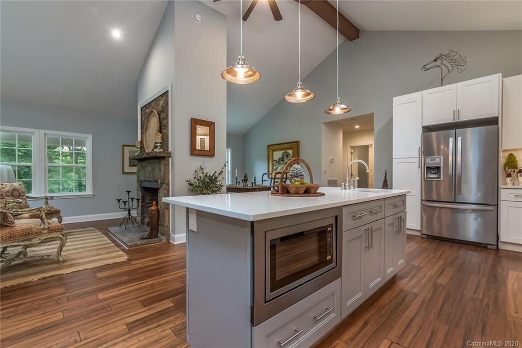 603 Vineyard Road Tryon, NC 28782 - Photo 9 of 39 a kitchen with stove a refrigerator and chairs