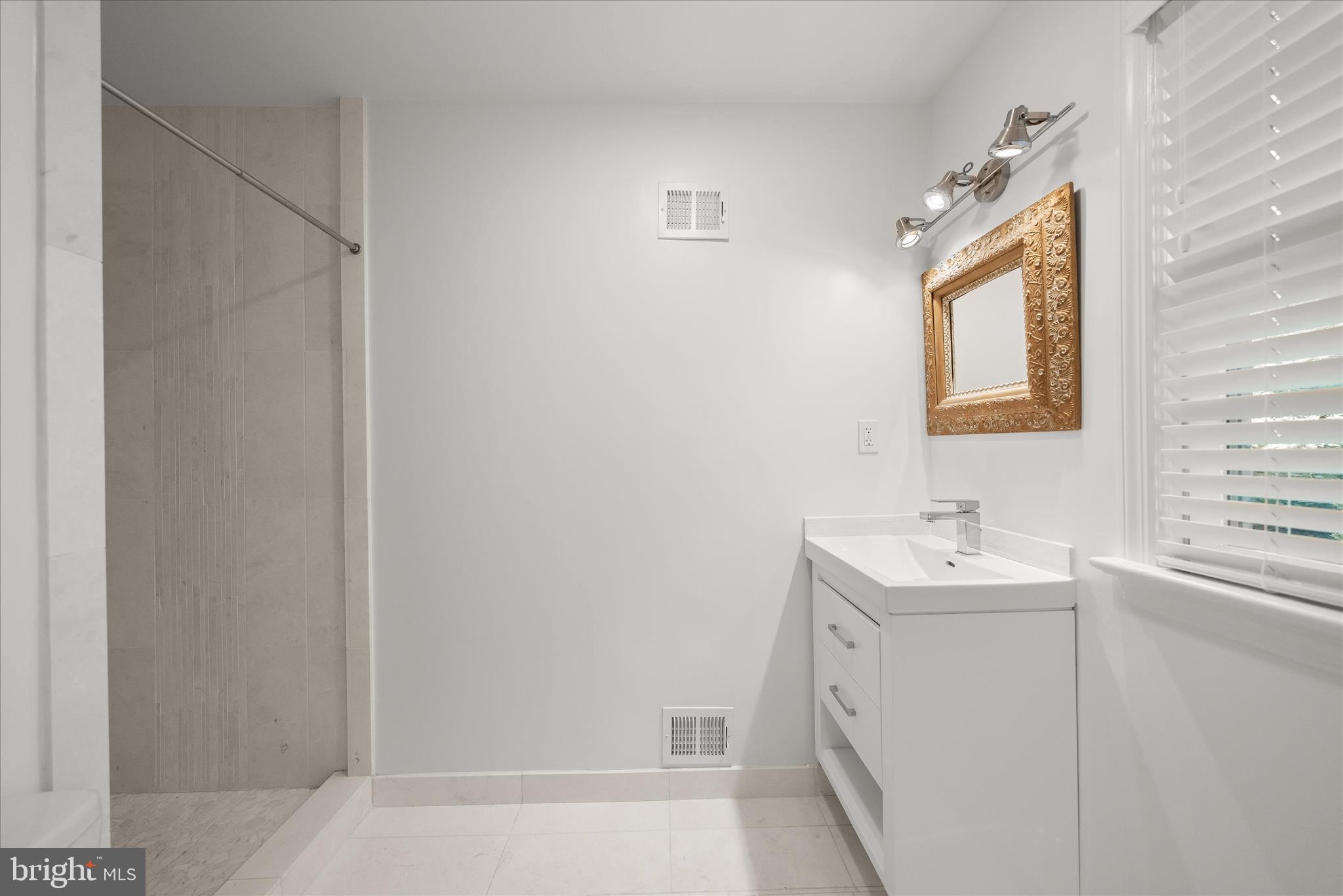5104 Scarsdale Road Bethesda, MD 20816 - Photo 26 of 68 a bathroom with a sink a toilet and mirror