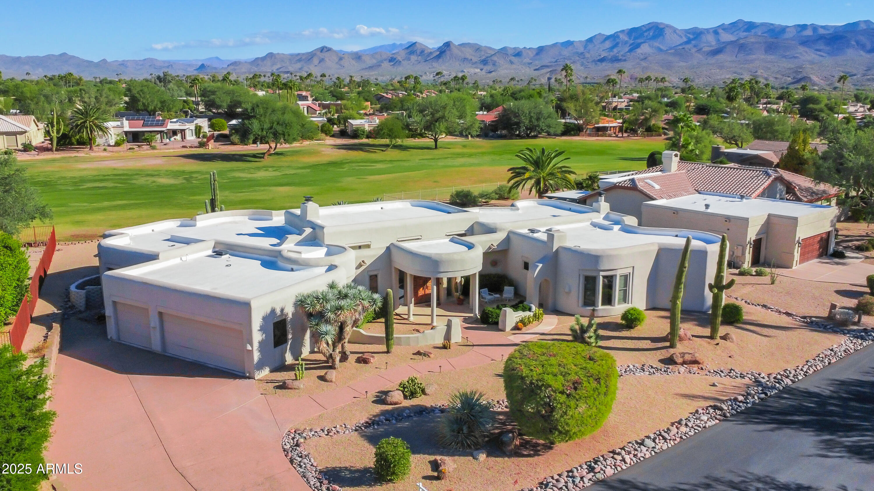 18830 East White Wing Drive Rio Verde, AZ 85263 - Photo 1 of 36 a view of a patio with couches table and chairs under an umbrella