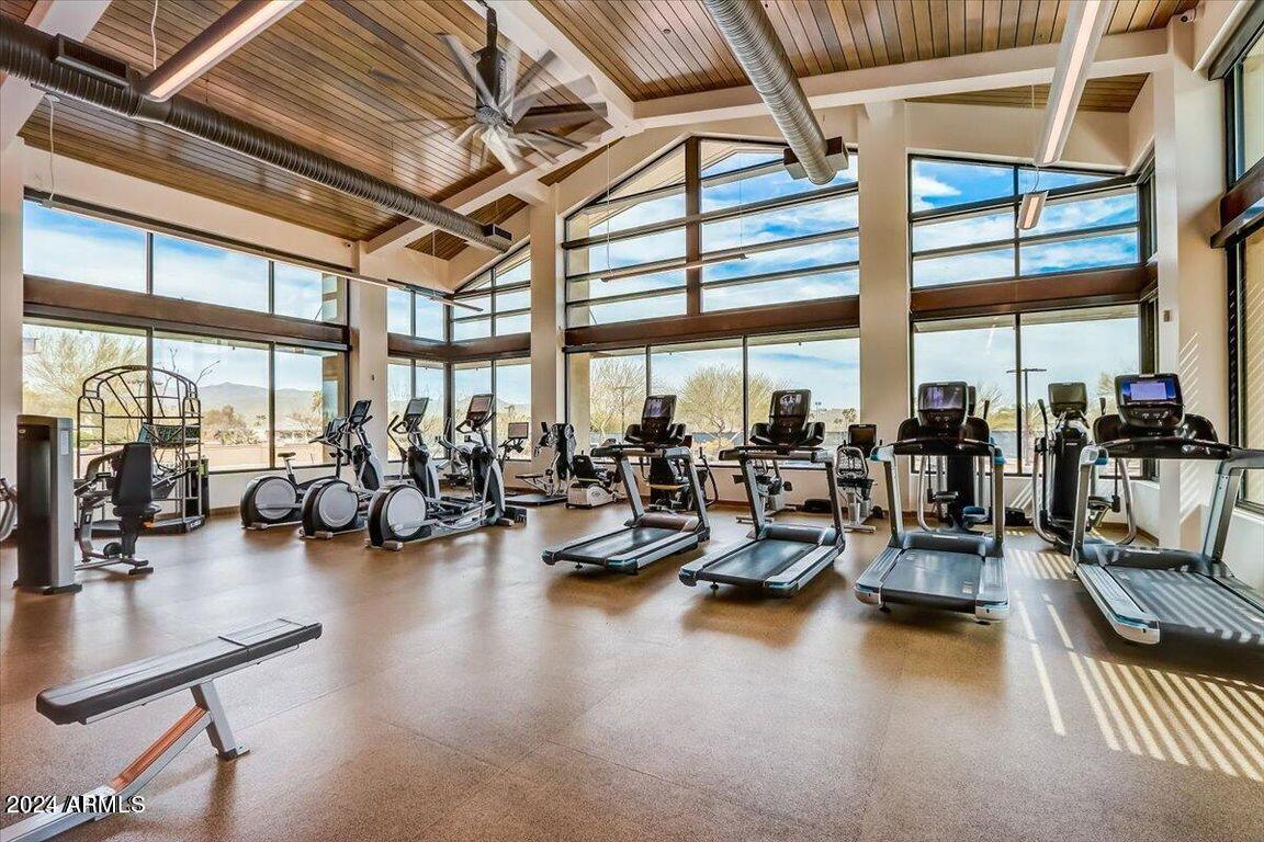 18830 East White Wing Drive Rio Verde, AZ 85263 - Photo 32 of 36 a gym room with lots of furniture and floor to ceiling windows