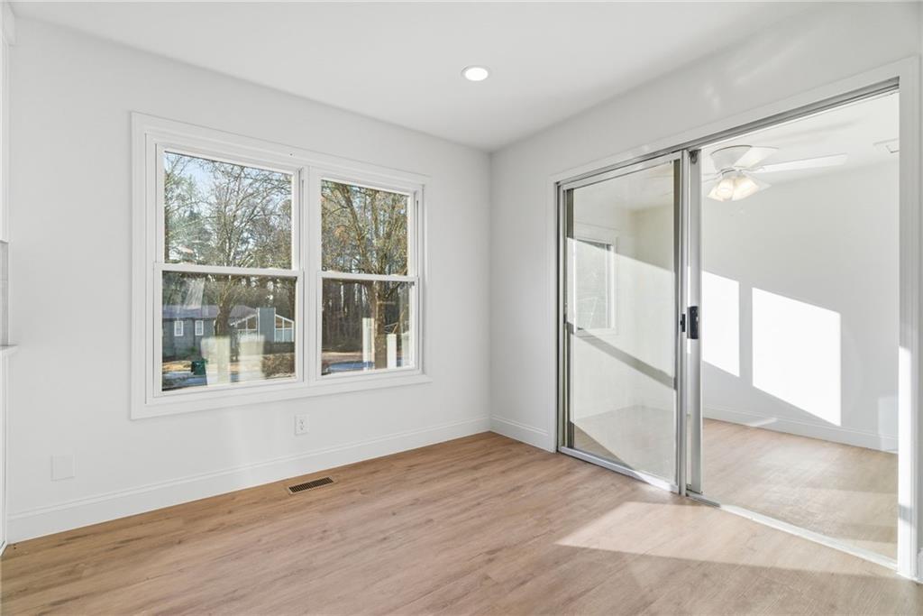 3447 Dry Creek Road Marietta, GA 30062 - Photo 17 of 42 an empty room with wooden floor and windows