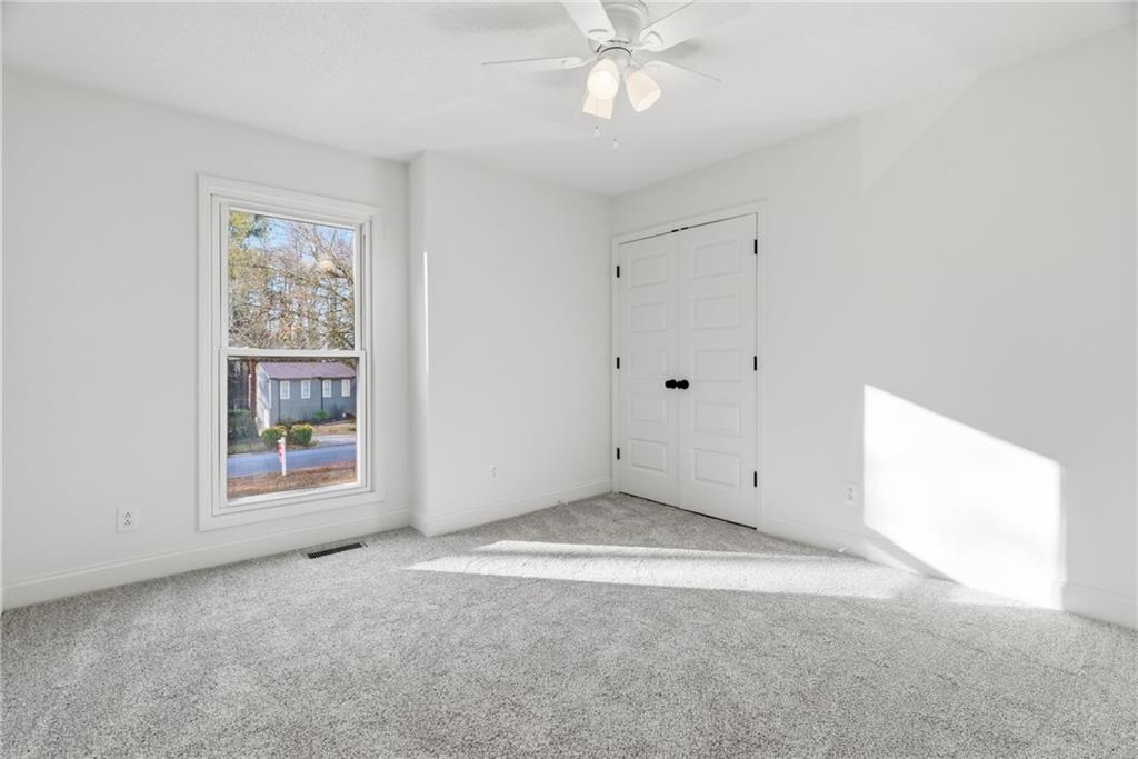 3447 Dry Creek Road Marietta, GA 30062 - Photo 23 of 42 an empty room with windows and fan