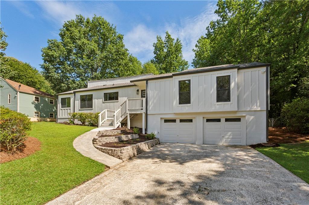 3447 Dry Creek Road Marietta, GA 30062 - Photo 3 of 42 a front view of a house with garden
