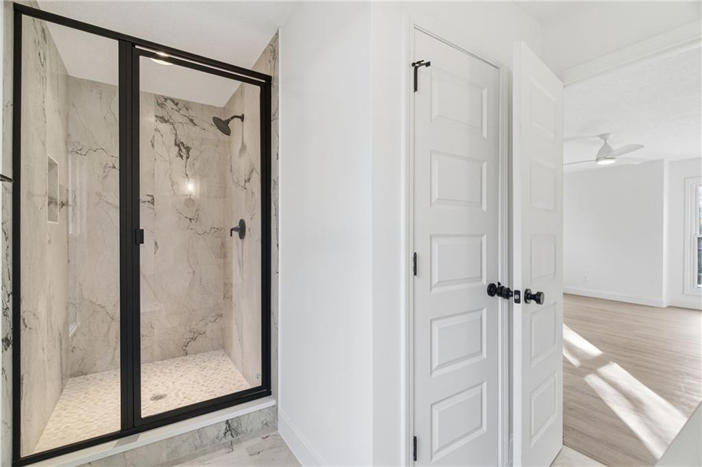 3447 Dry Creek Road Marietta, GA 30062 - Photo 31 of 42 a bathroom with a glass shower door