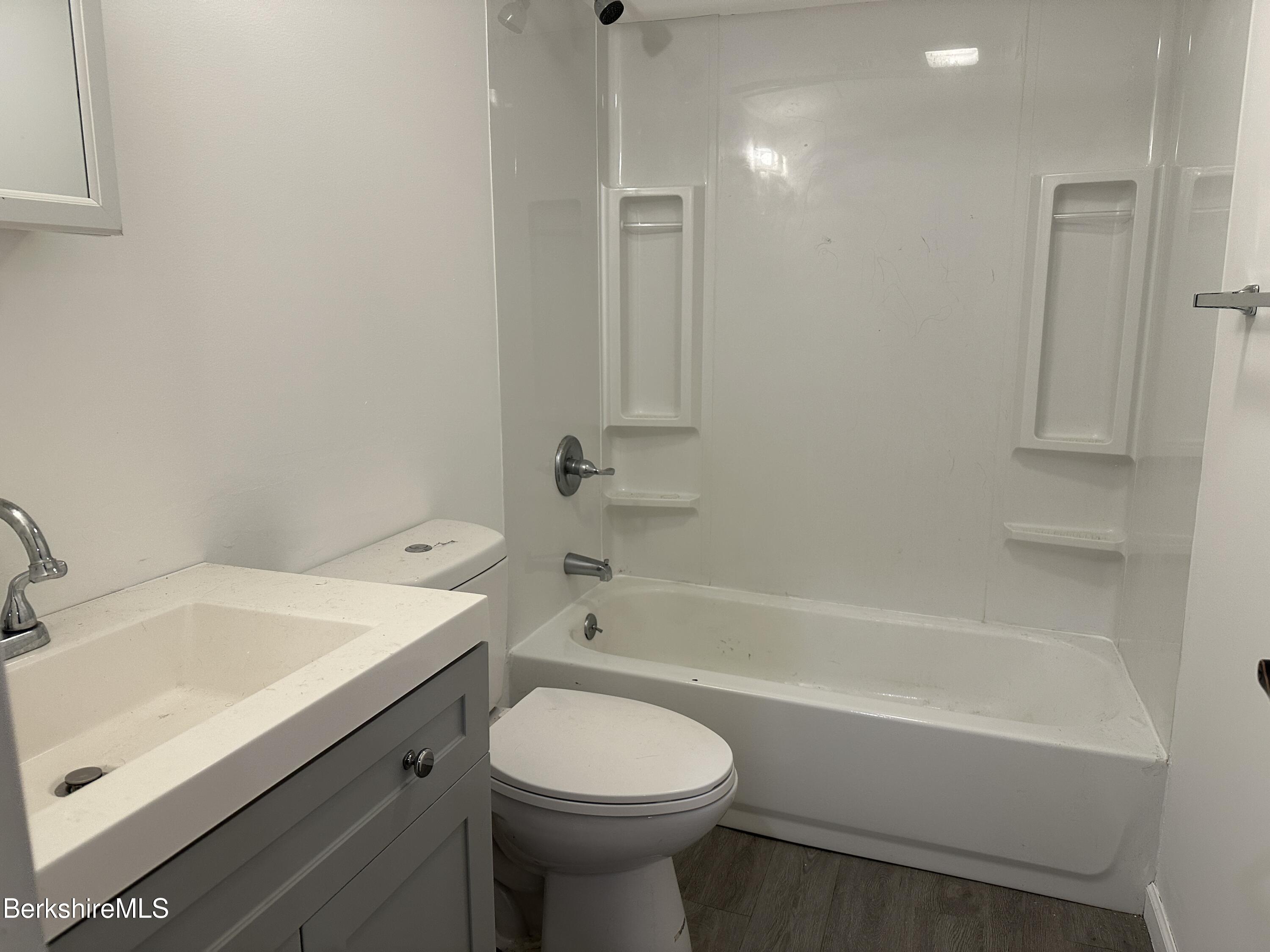 235 East Street, Unit 26 Pittsfield, MA 01201 - Photo 7 of 7 a bathroom with a sink toilet vanity and bathtub