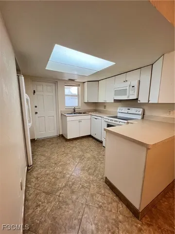 a kitchen with cabinets stove and a sink