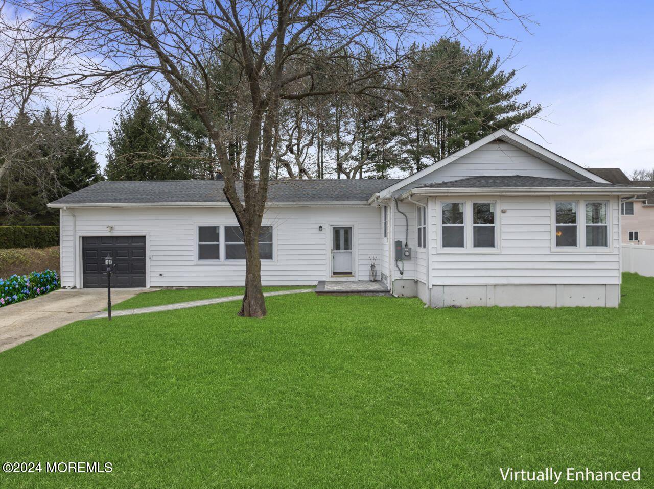 a front view of a house with a garden