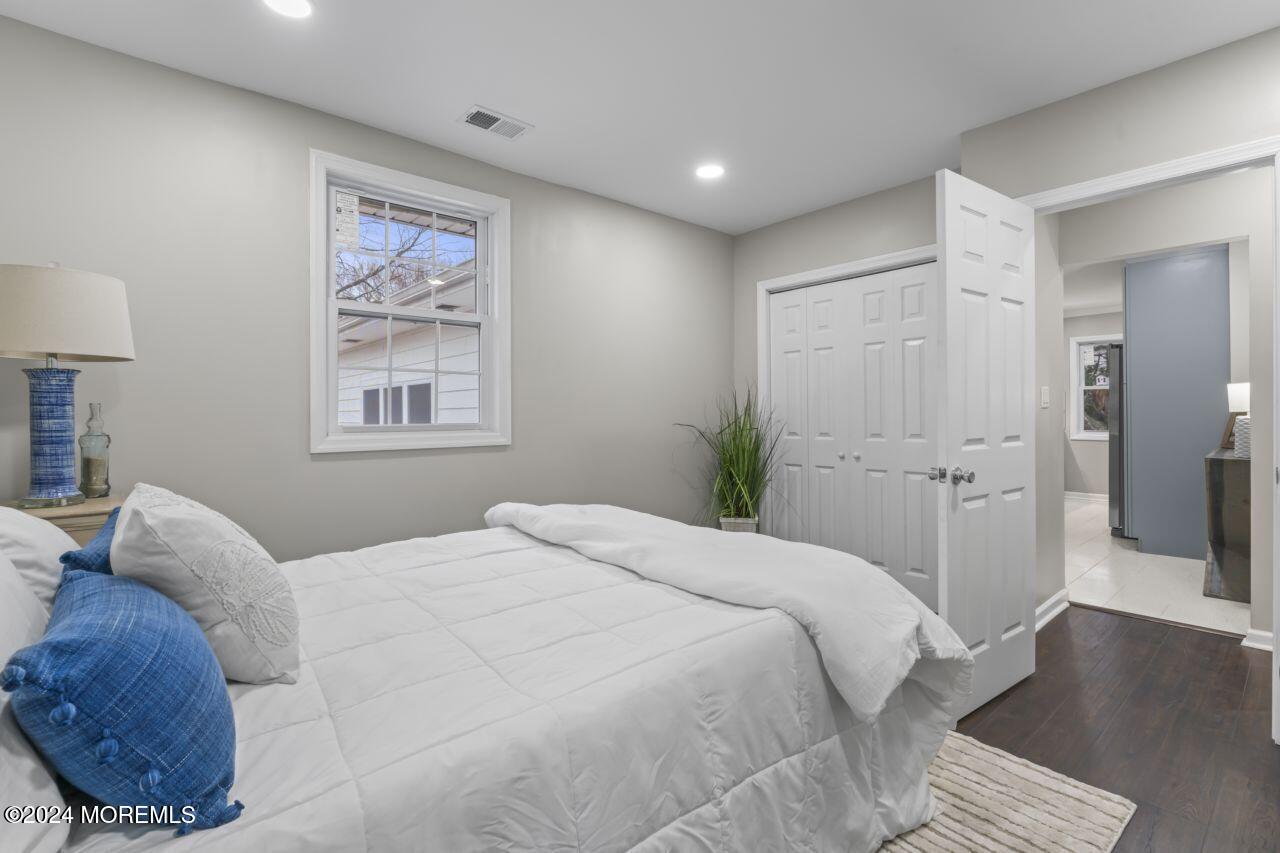 13 Texas Road Matawan, NJ 07747 - Photo 21 of 38 a bedroom with a bed and a painting on the wall