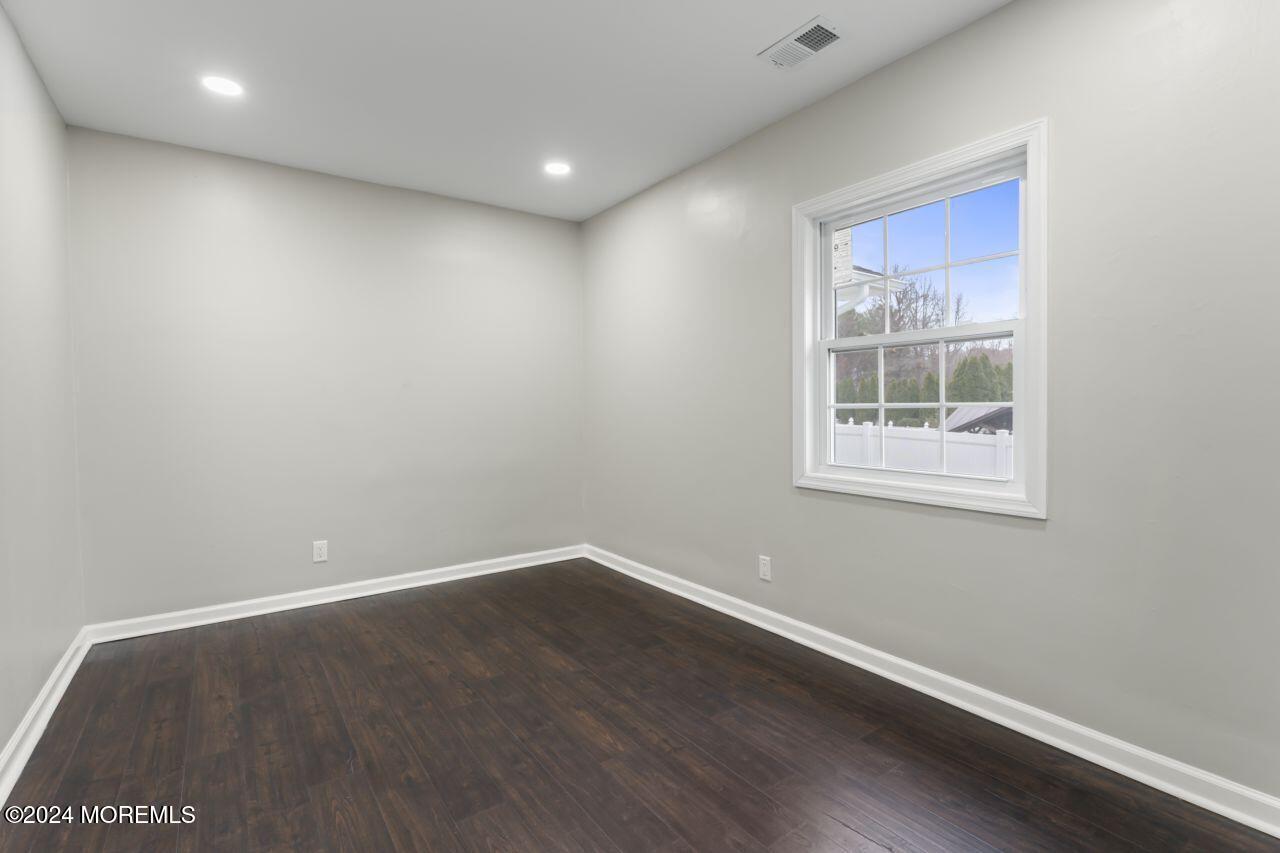 13 Texas Road Matawan, NJ 07747 - Photo 22 of 38 an empty room with wooden floor and windows