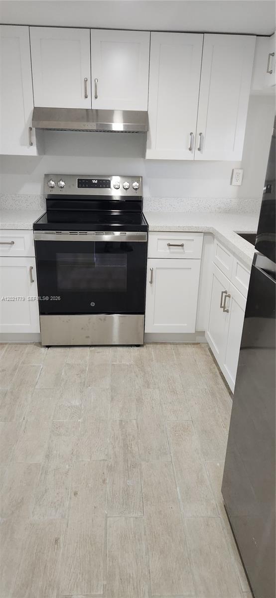 11800 Southwest 18th Street, Unit 4094 Miami, FL 33175 - Photo 2 of 14 a stove top oven sitting inside of a kitchen