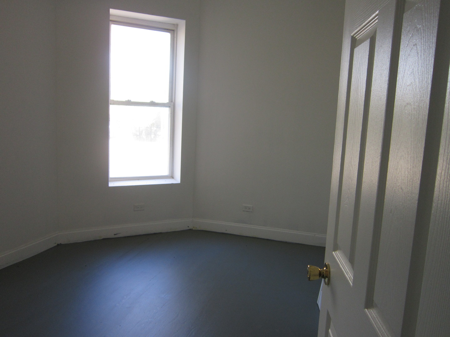 4035 West Harrison Street, Unit 1 Chicago, IL 60624 - Photo 7 of 12 an empty room with a window