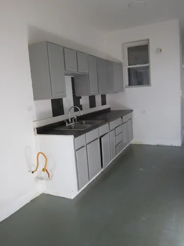 a kitchen with a sink and a stove