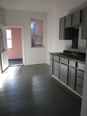 a kitchen with stainless steel appliances a stove refrigerator sink and cabinets