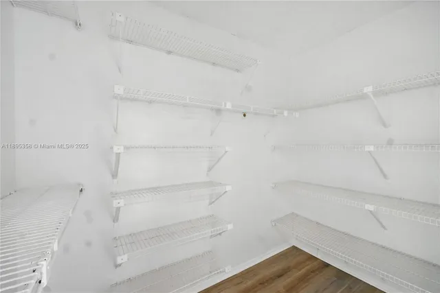 a view of walk in closet with empty racks