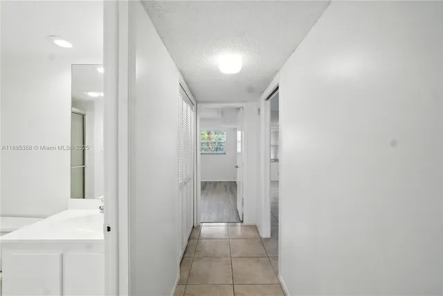 a view of a hallway with wooden shelves