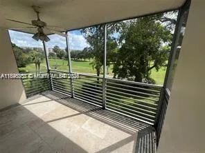 a view of a balcony with floor to ceiling windows and wooden floor