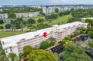 an aerial view of a house with a yard and lake